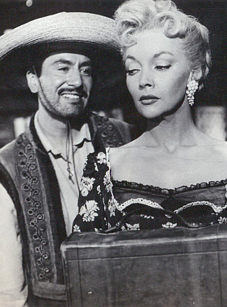 Rodolfo Hoyos Jr. as Lorenzo Garcia and Mari Blanchard as Barbara Duval in Stagecoach to Fury (1956)
