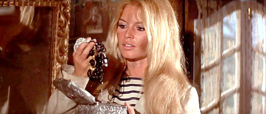 Brigitte Bardot as Maria II, admiring her soon-to-be partner's jewelry collection in Viva, Maria! (1965)
