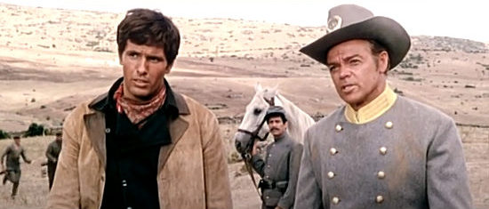 Giuliano Gemma (Montgomery Wood) at Gary Hammond, warning Capt. Taylor (Lorenzo Robledo) of a looming massacre in Fort Yuma Gold (1966)