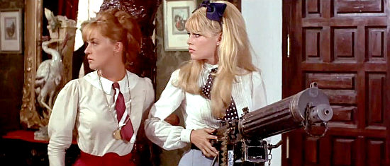 Jeanne Moreau as Maria I and Brigitte Bardot as Maria II about to put a machine gun to use in Viva Maria! (1965)