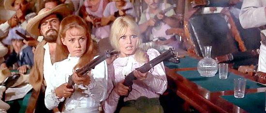 Jeanne Moreau as Maria I and Brigitte Bardot as Maria II simultaneously fire on of the last shots of the revolution in Viva Maria! (1965)
