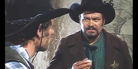 Remo Capitani as Sheriff Jack, with a snuff box or evidence in The Beast (1970)