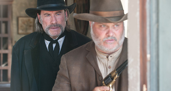 John Travolta as the marshal with Tommy Nohilly as Tubby in In the Valley of Violence (2016)