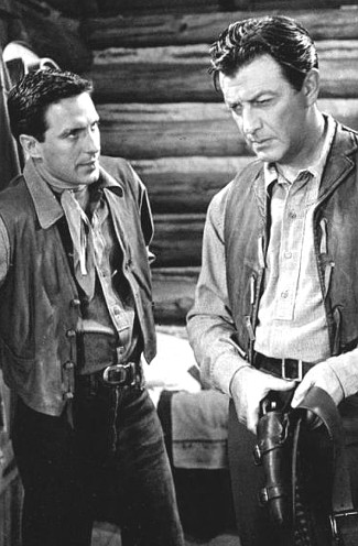 John Cassavetes as Tony Sinclair and Robert Taylor as Steve Sinclair in Saddle the Wind (1958)