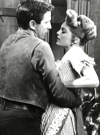 John Cassavetes as Tony Sinclair with Julie London as Joan Blake in Saddle the Wind (1958)