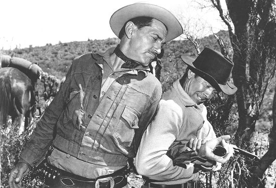 Kent Taylor as Johnny Barnes and Gene Nelson as Gil Shepard fight over a gun in The Purple Hills (1961)