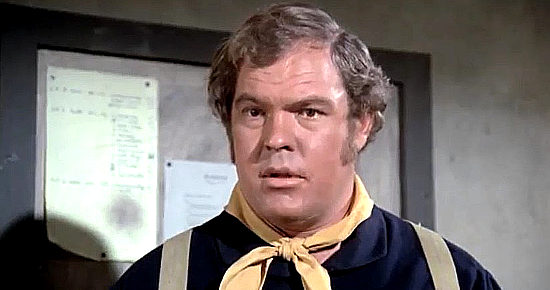 Merlin Olsen as Sgt. Fitzsimmons is befuddled by Dover's arrival in Something Big (1971)