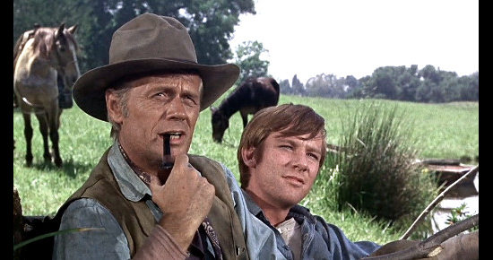 Richard Widmark as Frank Patch and Michael McGreevy as Dan Joslin get visitors during their fishing trip in Death of a Gunfighter (1969)