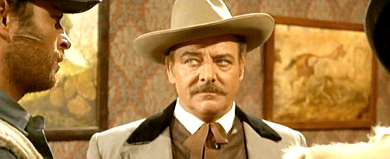 Alfonso Rojas as Amos Bransbury, leader of the ranchers, in Some Dollars for Django (1966)