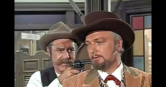 Jim Backus as Staunch, the mayor and sheriff, with a gun on Roger Hand (Jack Cassidy) in The Cockeyed Cowboys of Calico County (1970)