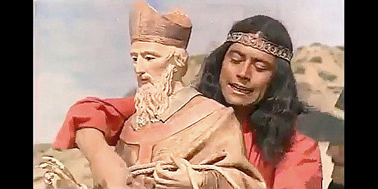 Juan Miguel as Apache Joe secures the statue of San Fermin for a theft in Too Much Gold for One Gringo (1972)