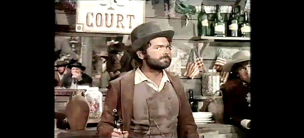 Pierre Perrett as Judge Roy Bean keeps order in his courtrrom with a gun in Judge Roy Bean (1971)