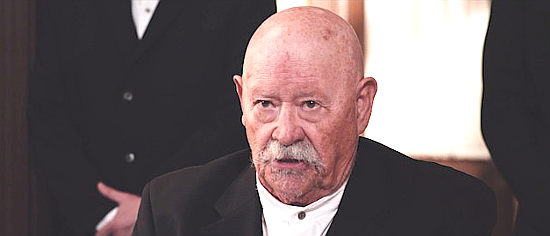 Barry Corbin as Noah, leader of the religious sect in Eminence Hill (2019)
