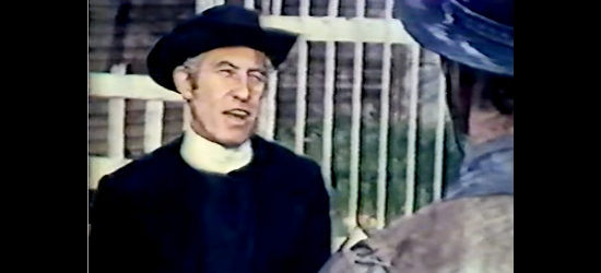 Bill Vanders as Father O'Hara, the priest who dares intervene in A Gunman Called Dakota (1972)