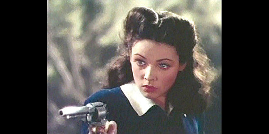 Gene Tierney as Belle Starr, showing Sam she can shoot in Belle Starr (1941)