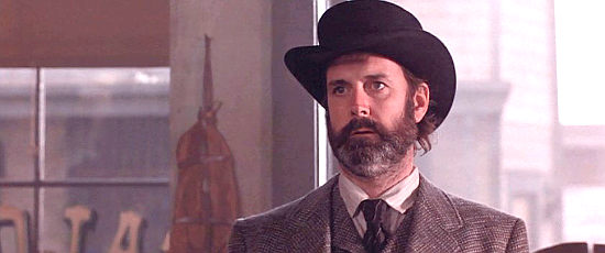 John Cleese as Sheriff Langston, lawman in Turley in Silverado (1985)
