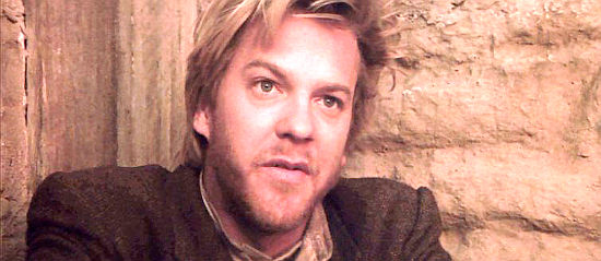 Kiefer Sutherland as Doc Surlock, questioning his future if he keeps riding with Billy in Young Guns II (1990)