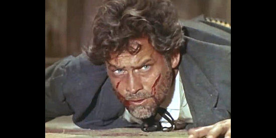 Carl Mohner as Larry Kitchener, beaten and bloodied by Reyes' men in The Man Who Came to Kill (1965)