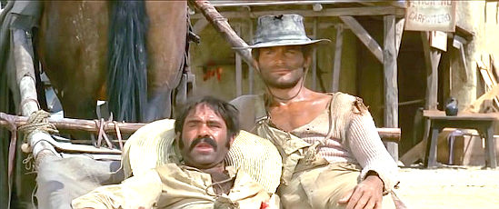 Michele Cimarosa as Chico and Terence Hill as Trinity watch Bambino square off against three of Maj. Harrison's men in They Call Me Trinity (1970)