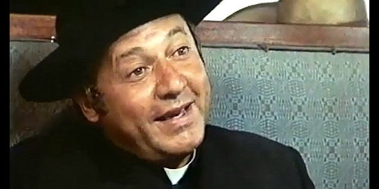 Paol Villaggio as Padre Don Albino Moncarlieri, trying to ignore actors' vulgarity on a train ride in What Am I Doing in the Middle of a Revolution (1972)