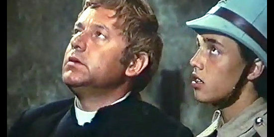 Paol Villaggio as Padre Don Albino Moncarlieri with a young soldier about to take him to a firing squad in What Am I Doing in the Middle of a Revolution (1972)