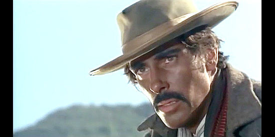 Robert Woods as Fernando Camayo watching a landowner toss bread to the peons in Pray to God and Dig Your Grave (1968)
