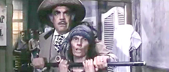 Grant (Eduardo Fajardo) tussles with Ma Manure (Maria Vico) over the deed to a mine in Tedeum (1972)