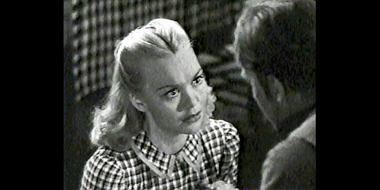 Jane Wyman as Mary Hathaway tries to convince fiancee Jim Younger to change his thieving ways in Bad Men of Missouri (1941)