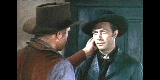 Robert Taylor as Billy the Kid invites one of Hickey's men to check if he's wet behind the ears in Billy the Kid (1941)