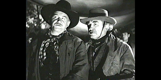 Tom Tully as cattleman John Lofton and Bud Osborne as foreman Cap Willis, suspicious of a stranger in Blood on the Moon (1948)