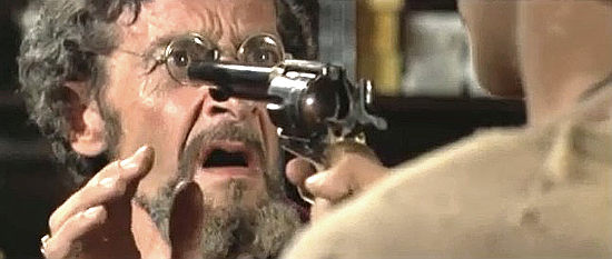 Francisco Sanz as the gunsmith, held up with one of his own guns in Ben and Charlie (1972)