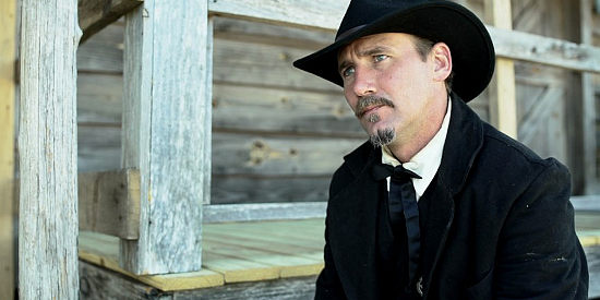 Paul Clayton as Wyatt Earp, reviewing what went wrong when a woman was gunned down in Wyatt Earp Shoots First (2019)