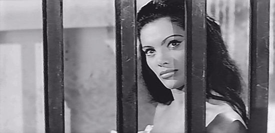 Sylvia Sorrente as Lolita, the cantina entertainer, snooping on Lt. Alberto Kalman in The Jaguar (1963)