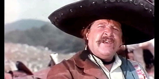 Fernando Sancho as El Bicho, entertaining a proposal that might make him rich in Winchester Bill (1967)