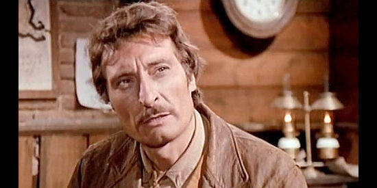 Gilberto Galimberti (Gill Roland) as Deputy Collins, arguing with the sheriff again in In the Name of the Father, the Son and the Colt (1971)
