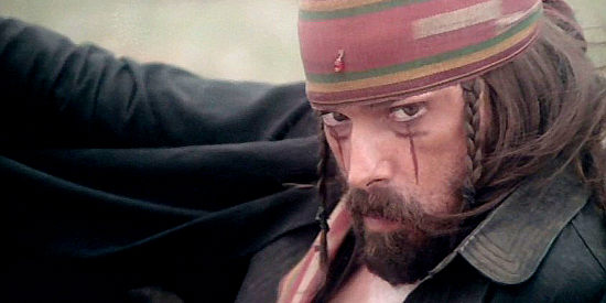 Tomas Milian as Chaco, making plans for Bunny while he's got her and her fellow travellers tied up in Four of the Apocalypse (1975)