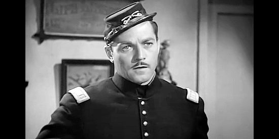 Alan Curtis as Capt. Fred Raymond, the officer trying to find and capture a female outlaw in Renegade Girl (1946)
