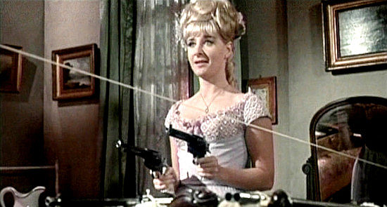 Angela Douglas as Annie Oakley, ready to spring her ambush with two pistols, a rifle and a shotgun in Carry On Cowboy (1966)