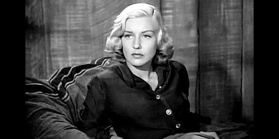 Ann Savage as Jean Shelby, listening to a warning from gang member Bob Crandell in Renegade Girl (1946)