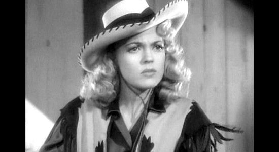 Anne Gwynne as Anne Shaw, concerned about a $10,000 bet against the Lazy S Ranch in Ride 'Em Cowboy (1942)