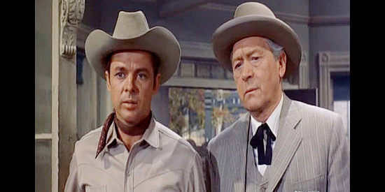 Audie Murphy as Banner Cole and James Bell as Benson, a town leader in Posse from Hell (1961)