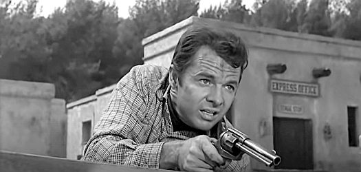 Audie Murphy as Chris Foster, involved in a gunfight on the streets of Adonde in Showdown (1963)