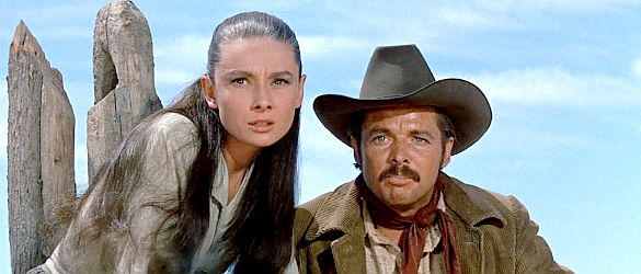 Audrey Hepburn as Rachel Zachary and brother Cash (Audie Murphy) watching Ben confront a ranch hand in The Unforgiven (1960)