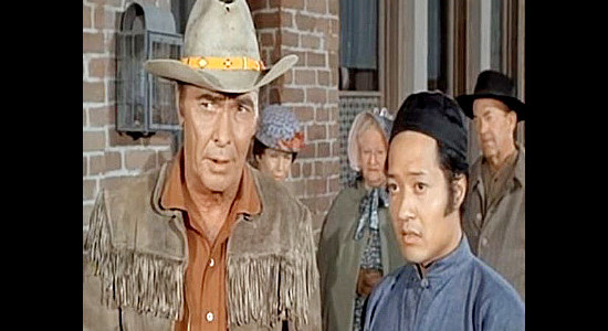 Barry Sullivan as Chaddock with Sung Li (Aki Aleong), a helper at the general store who befriends Chaddock's son in Buckskin (1968)