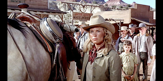 Bibi Andersson as Ellen Grange, delivered back home by Jess Remsberg as the townfolks look on in Duel at Diablo (1966)