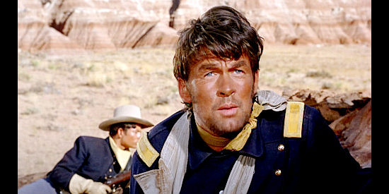 Bill Travers as Lt. Scotty McAllister, on the watch for another attack by the Apaches in Duel at Diablo (1966)