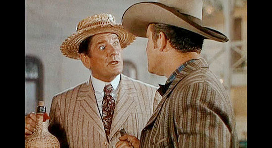 Bob Burns as Sam Slade, chatting with the sheriff upon his arrival in Malemute in Belle of the Yukon (1944)