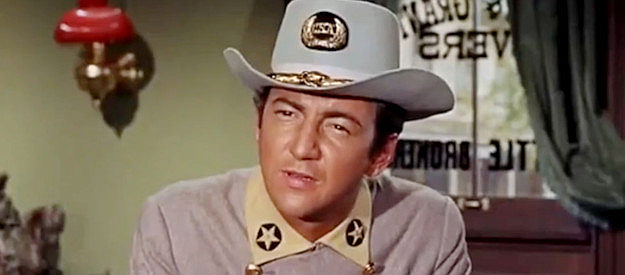 Bobby Darin as Cal Wayne, listening to longtime friend Grant Evers talk about his grand ambitions in Gunfight in Abilene (1967)