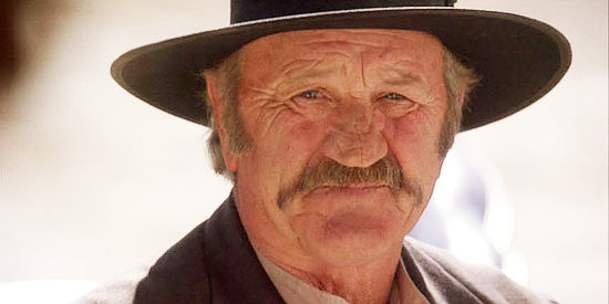 Boots Sutherland as Nathan Mitchell, the rancher who wants the Bakers' land in Doc West (2009)