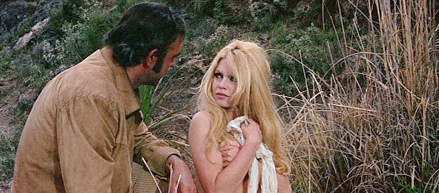 Brigitte Bardot as Irina Lazaar covering her body when Shalako (Sean Connery) catches her bathing in Shalako (1968)